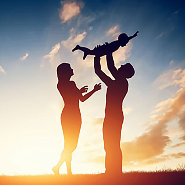 family playing at sunset