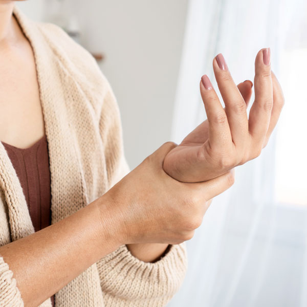 woman feeling wrist with carpal tunnel