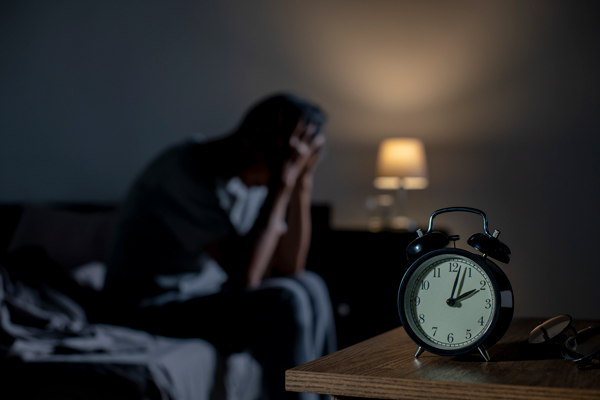 man holding head in stress