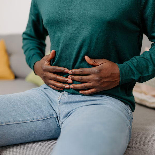 Man holding stomach from pain